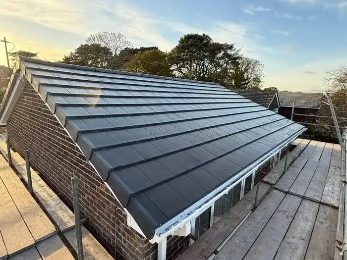 Full re-roof — finished, new tiles from the scaffold