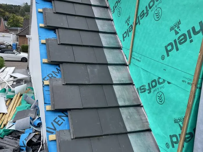 Re-roof — new slate tiles being laid
