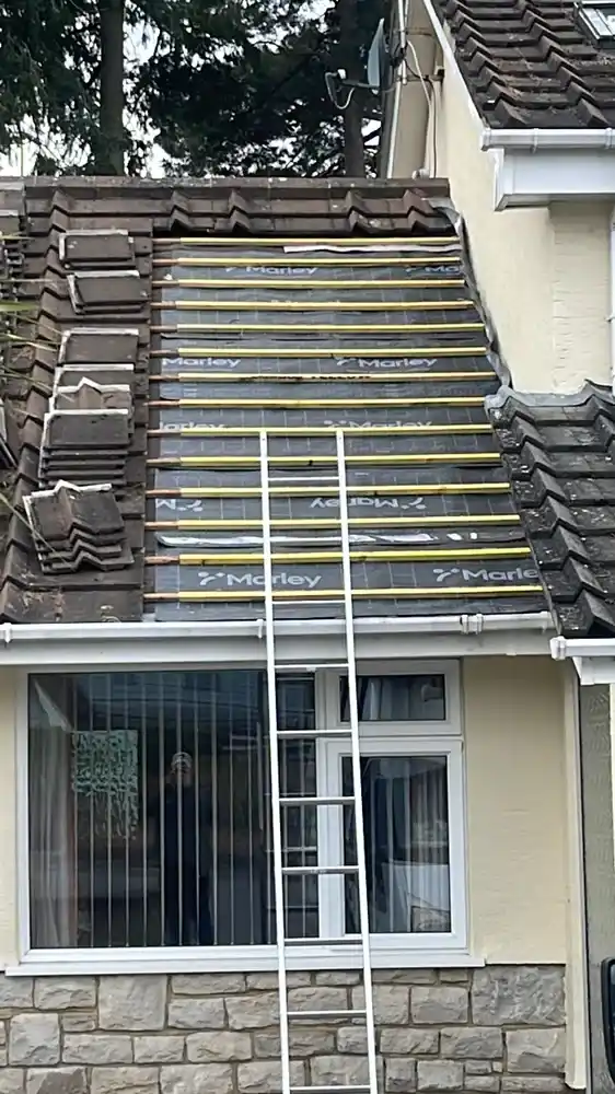 Roof repair — a section re-felted and battened around a bay window roof