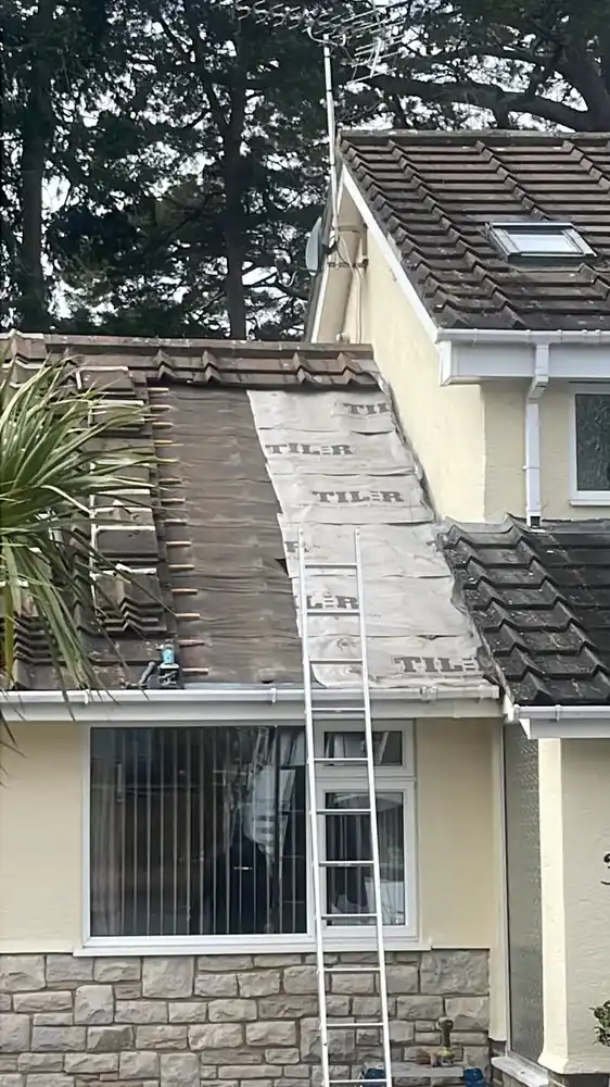 Roof repair — old roofing felt exposed after removing tiles to inspect the deck